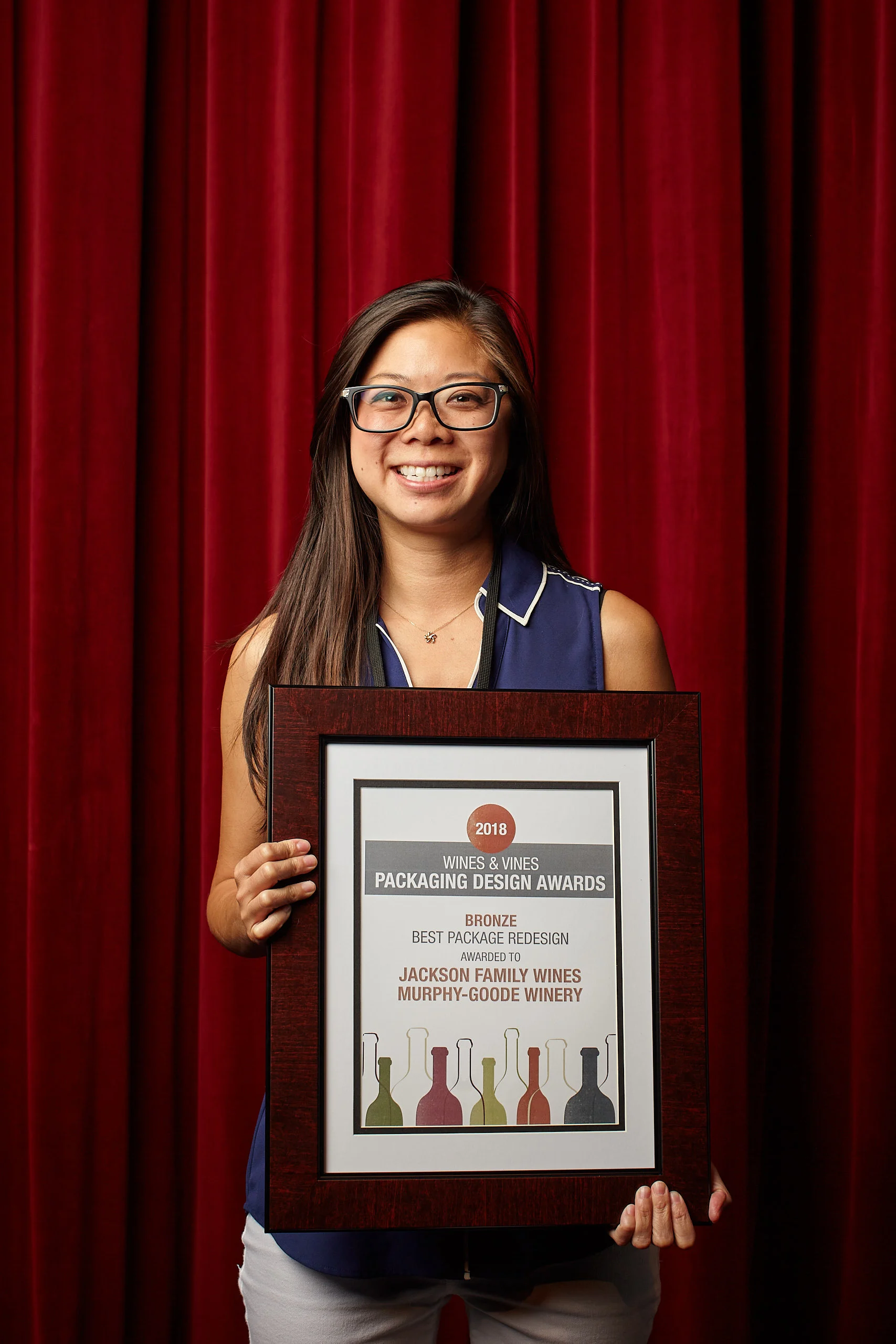 Professional event photography by San Francisco photographer; Bronze award winner for Best Package Redesign at the Napa Valley Wine Label Awards, captured against a red velvet backdrop.